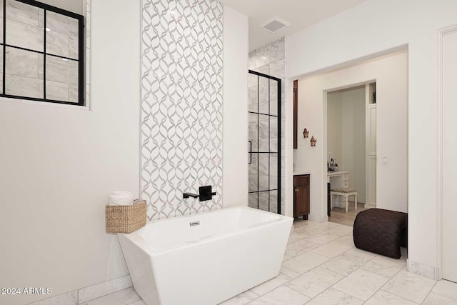 bathroom featuring shower with separate bathtub