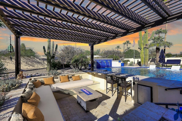 patio terrace at dusk featuring a pergola, pool water feature, an outdoor living space with a fire pit, and exterior bar