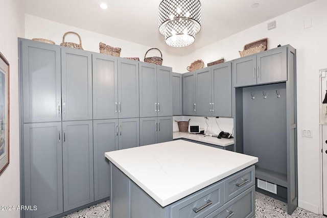 kitchen with gray cabinetry and a center island