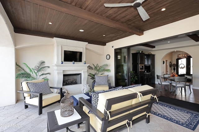 view of patio featuring an outdoor living space with a fireplace and ceiling fan