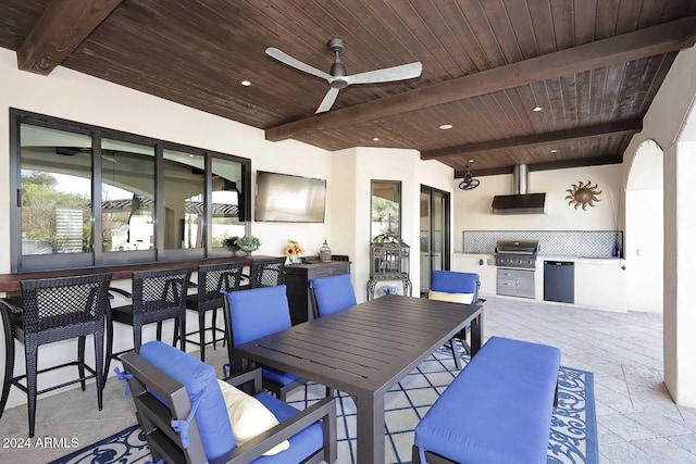 view of patio with a bar, an outdoor hangout area, area for grilling, and ceiling fan