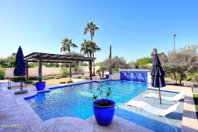 view of swimming pool featuring pool water feature, a patio, and a pergola