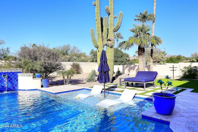 view of pool featuring pool water feature and a patio area