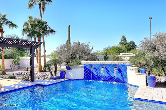 view of swimming pool with pool water feature and a pergola