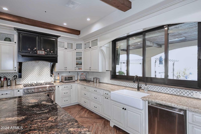 kitchen with white cabinets, dark parquet floors, sink, and appliances with stainless steel finishes