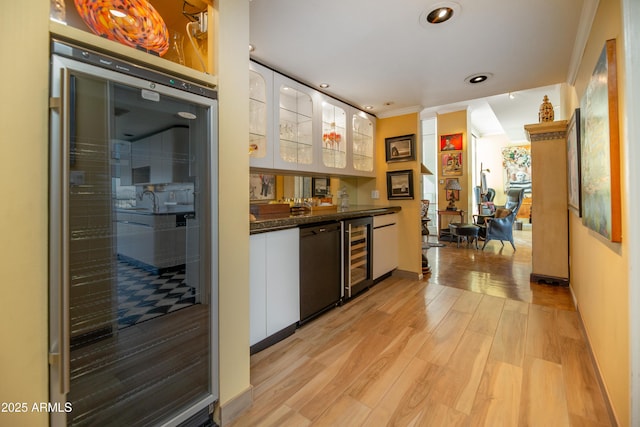 bar featuring light wood finished floors, indoor bar, beverage cooler, dishwasher, and recessed lighting