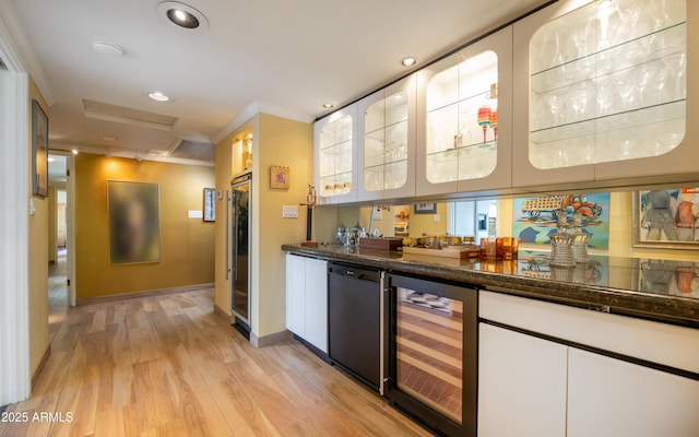 bar featuring a bar, wine cooler, recessed lighting, and light wood-type flooring