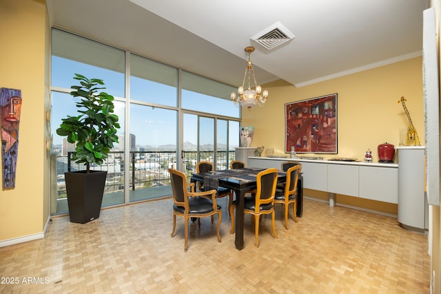 dining area with visible vents, a view of city, ornamental molding, baseboards, and a chandelier