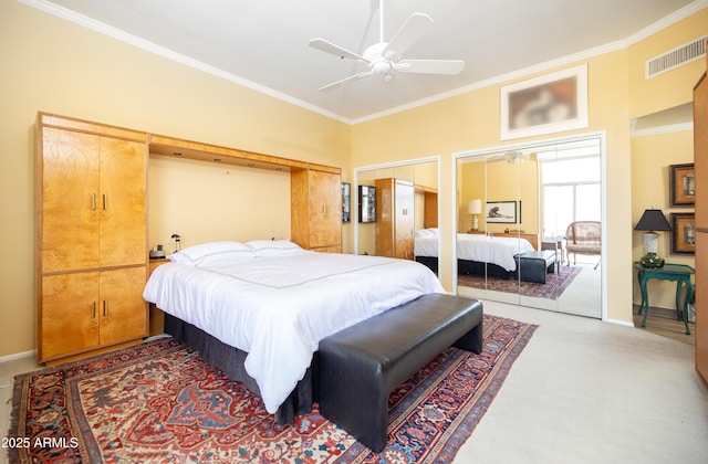 carpeted bedroom featuring a ceiling fan, crown molding, baseboards, and visible vents