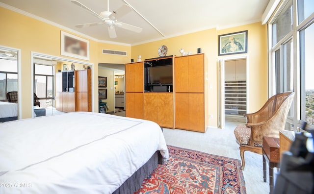 bedroom featuring visible vents, crown molding, a ceiling fan, and carpet floors