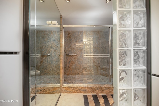 bathroom with recessed lighting and a shower stall