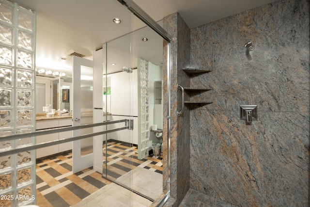 full bath with a shower stall and visible vents