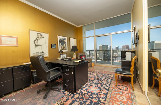 home office with crown molding, floor to ceiling windows, and wood finished floors