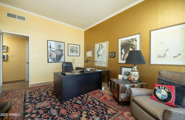 office space featuring wood finished floors, visible vents, baseboards, and ornamental molding