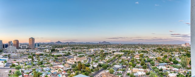 aerial view at dusk featuring a city view