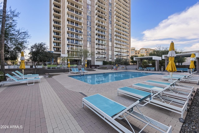 pool featuring fence and a patio area