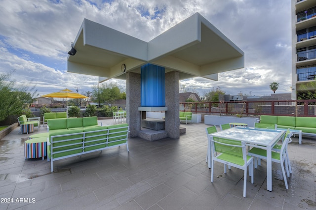 view of patio / terrace featuring an outdoor living space, outdoor dining space, and fence