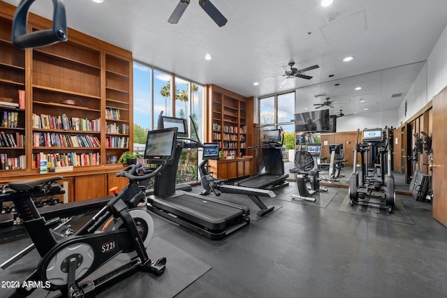 gym featuring a textured ceiling, recessed lighting, and expansive windows