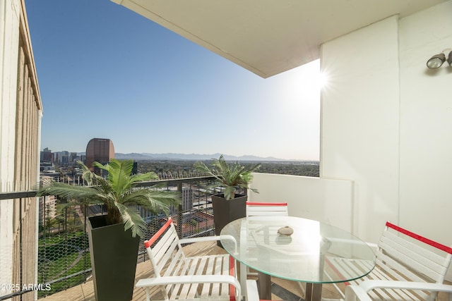 balcony with a city view and a mountain view