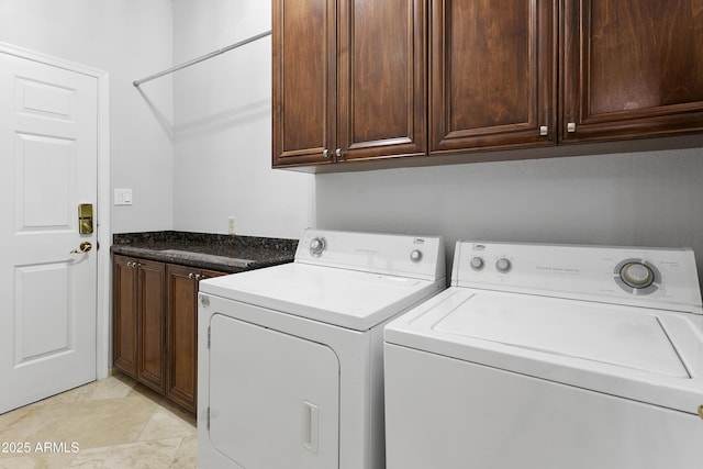 laundry room featuring cabinets and washer and dryer