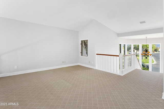 spare room with lofted ceiling and carpet flooring