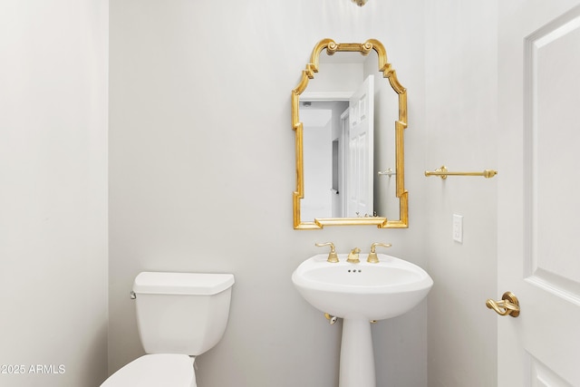 bathroom featuring toilet and sink