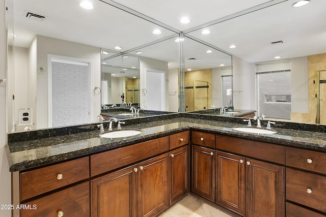 bathroom featuring vanity, tile patterned flooring, and walk in shower