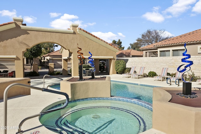 view of pool with a patio area and a hot tub