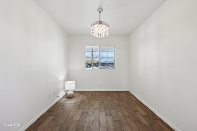 spare room featuring a notable chandelier