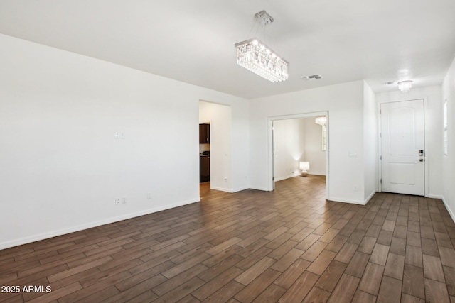 spare room featuring a notable chandelier