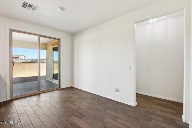 unfurnished room with a notable chandelier