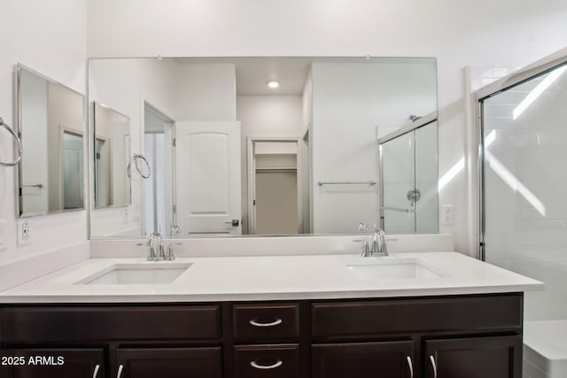 bathroom featuring walk in shower and vanity