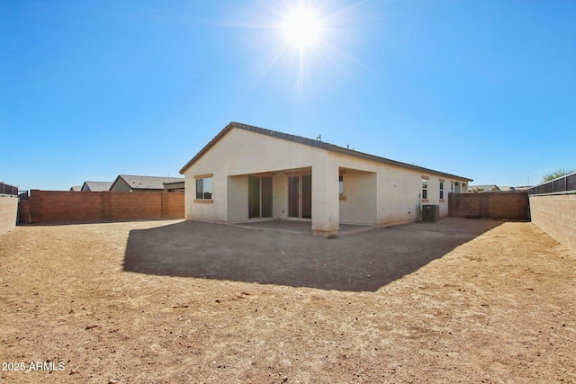 rear view of property featuring central AC and a patio area