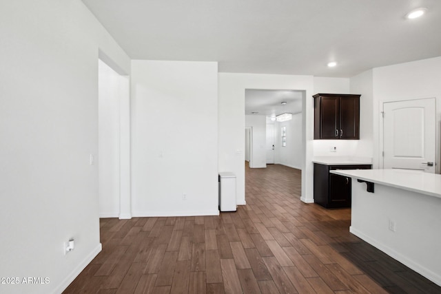 kitchen featuring dark hardwood / wood-style flooring and dark brown cabinetry