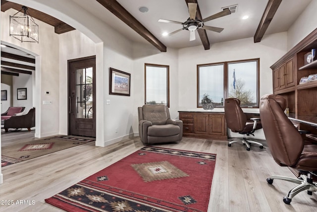 home office with beamed ceiling, light hardwood / wood-style floors, and an inviting chandelier