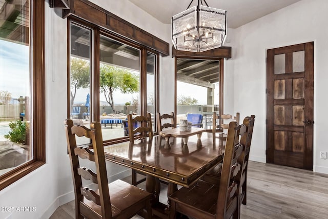 dining space with a notable chandelier and wood-type flooring