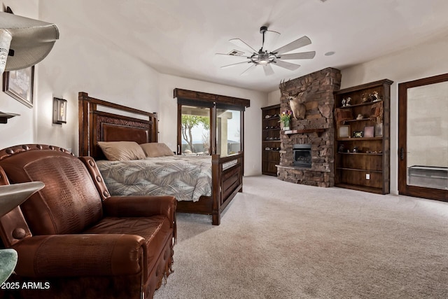 bedroom featuring ceiling fan, a fireplace, access to outside, and light carpet