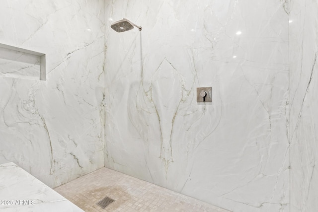 bathroom with tiled shower