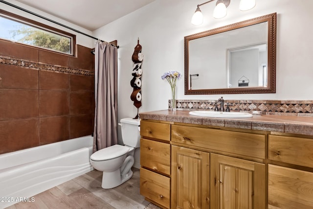 full bathroom featuring hardwood / wood-style floors, vanity, toilet, and shower / bath combo with shower curtain