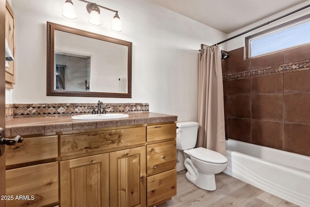 full bathroom with hardwood / wood-style floors, vanity, toilet, and shower / bath combination with curtain