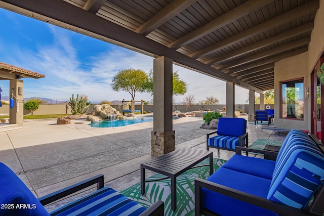 view of patio / terrace featuring pool water feature, a fenced in pool, and an outdoor hangout area