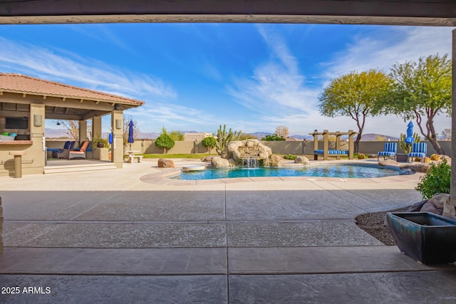 view of swimming pool featuring pool water feature and a patio