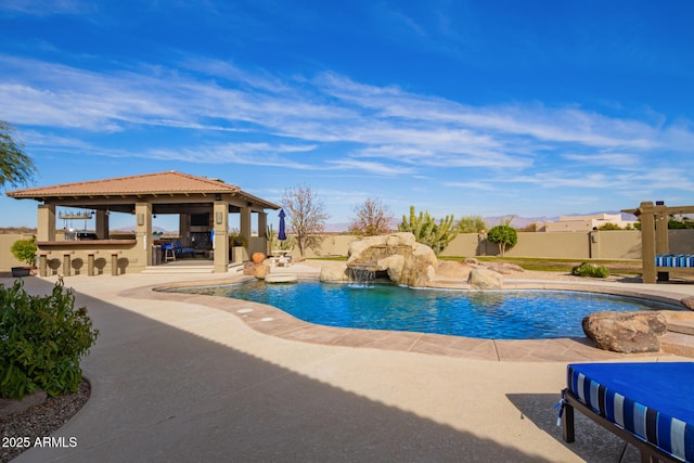 view of pool featuring a gazebo, pool water feature, an outdoor bar, and a patio