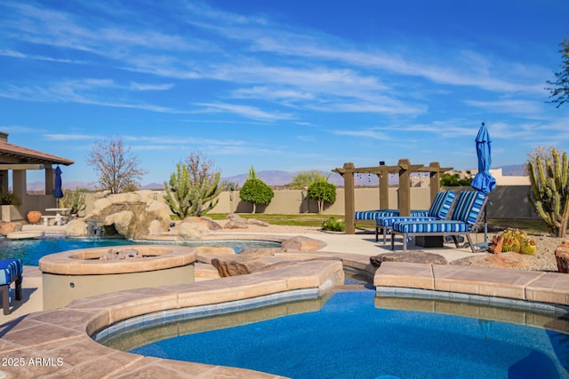 view of pool featuring an in ground hot tub and pool water feature