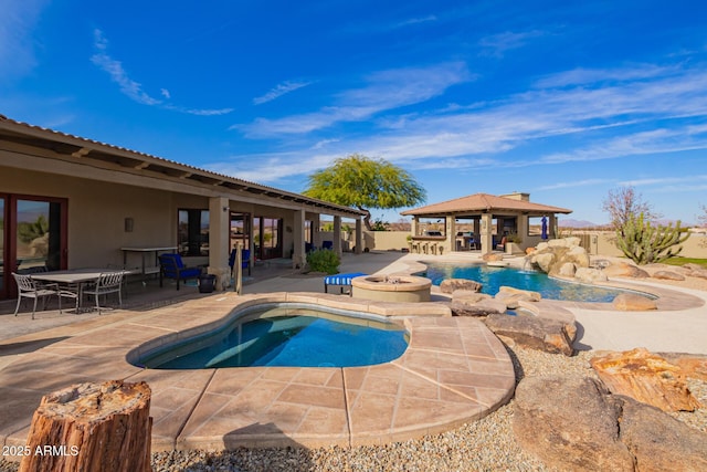 view of pool featuring a gazebo, a patio, and a hot tub