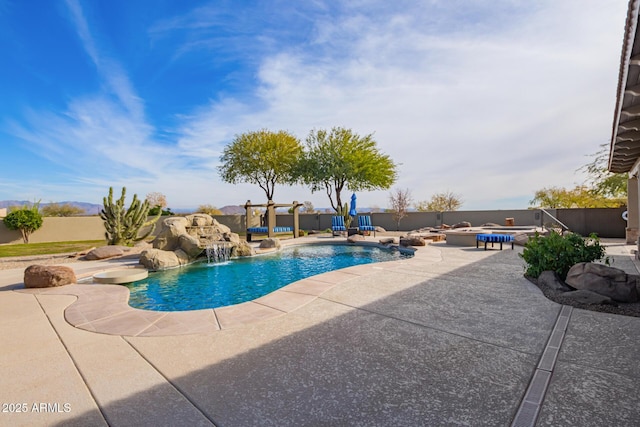 view of swimming pool with pool water feature and a patio area