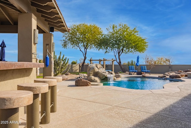 view of pool with pool water feature and a patio