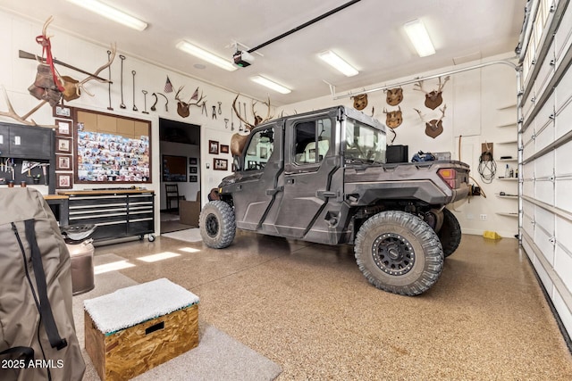 garage with a workshop area and a garage door opener