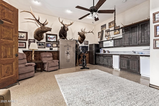 kitchen with ceiling fan, dark brown cabinets, and white appliances