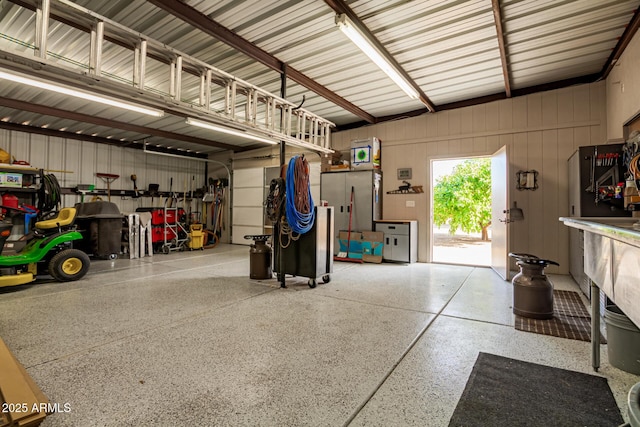 garage featuring wooden walls